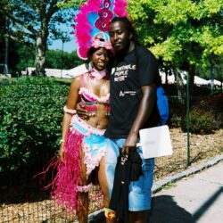 Two people posing in colorful carnival attire.