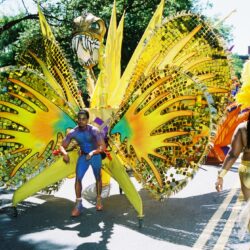 Carnival performers in vibrant, elaborate costumes.
