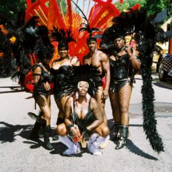 Carnival dancers wearing black feathered costumes