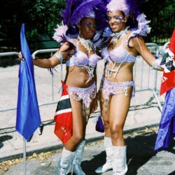Two carnival dancers in purple feathered costumes