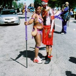 Two people in colorful carnival costumes at parade