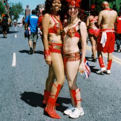 Two women in red carnival costumes at parade