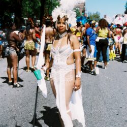 Carnival performer in white feathered costume