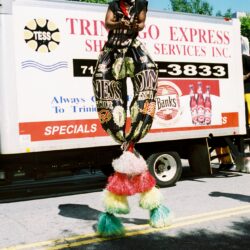 Person performing on stilts in vibrant costume.