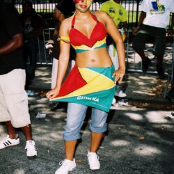 Woman celebrating in colorful carnival outfit.