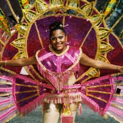 Carnival performer in vibrant, colorful costume.
