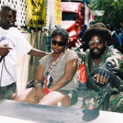 People sitting on a vehicle outdoors.
