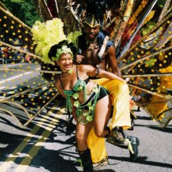 Carnival dancers in vibrant, feathered costumes.