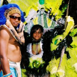 Carnival costumes with vibrant feathers and accessories.
