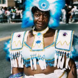 Person in blue and white feathered costume