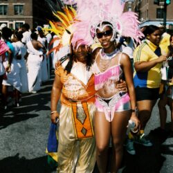 Two carnival dancers in pink and gold costumes