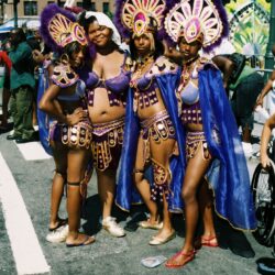 Four women in purple carnival costumes