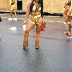 Carnival dancer in vibrant costume and boots.