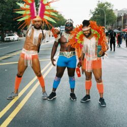 Three men in colorful carnival costumes.