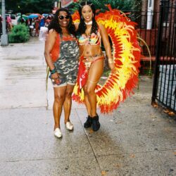 Two women in colorful carnival outfits.