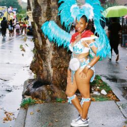 Carnival dancer in blue feathered costume.
