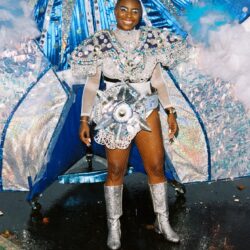 Person in sparkling blue and silver costume.