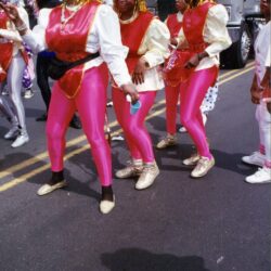Dance troupe in gold wigs and pink costumes