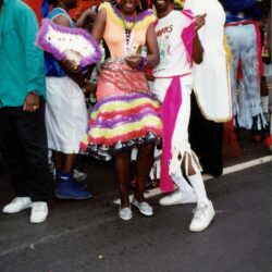Smiling dancers in colorful carnival costumes