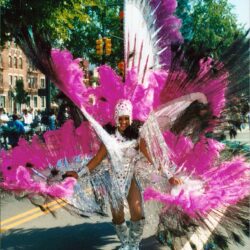 Performer in pink feathered carnival costume