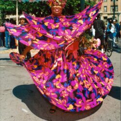 Dancer twirling vibrant floral skirt at street festival