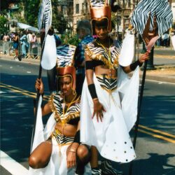 Two parade performers in zebra-themed costumes