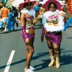 Two women in purple carnival costumes
