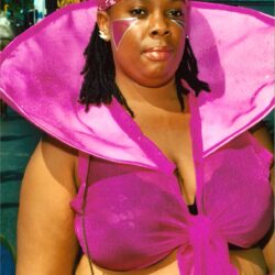 Person wearing vibrant pink costume and face paint