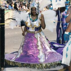 Person in ornate purple feathered carnival costume