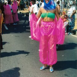 Smiling person in colorful parade costume