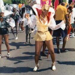 Dancer in gold costume and feathered headdress