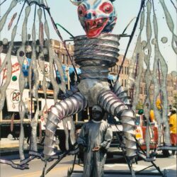 Giant metallic bat puppet in street parade