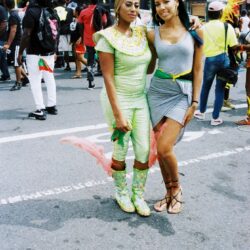 Two women in colorful outfits at street carnival