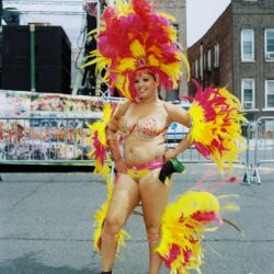 Woman in vibrant yellow and pink carnival costume