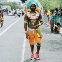 Man with feathered headdress at carnival parade