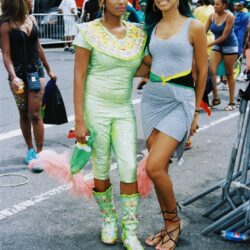 Two women posing at lively street parade