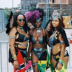 Three women in colorful carnival costumes