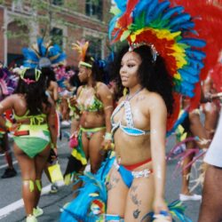 Woman dancing in colorful feathered carnival parade