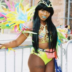 Woman in colorful carnival costume with feathers