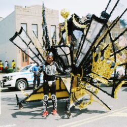 Carnival performer in elaborate black and gold costume