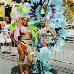 Two women in colorful feathered carnival costumes