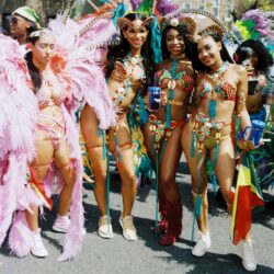Women in vibrant carnival parade costumes