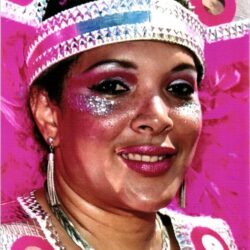 Woman in pink carnival costume with glittery makeup